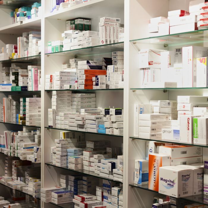 Pharmacy shelves filled with a variety of medicines